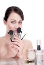 Woman with makeup brushes near the face. Royalty Free Stock Photo