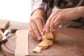 Woman making apple roses from puff pastry in kitchen Royalty Free Stock Photo