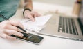 Woman making audit of household spendings at home, using calculator Royalty Free Stock Photo