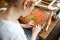 Woman making botanical plaster artwork in her home studio.