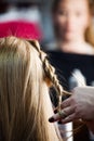 Woman making braids at hair studio Royalty Free Stock Photo