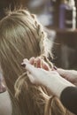 Woman making braids at hair studio Royalty Free Stock Photo