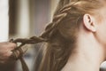 Woman making braids at hair studio Royalty Free Stock Photo