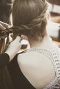 Woman making braids at hair studio Royalty Free Stock Photo