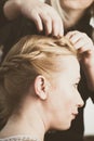 Woman making braids at hair studio Royalty Free Stock Photo