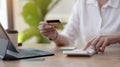 Woman making calculations and shopping online with credit card. Female using calculator, budget and loan paper in office. Bills, Royalty Free Stock Photo