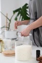 woman making candles from soy wax, working in her creative space
