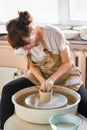 Woman making ceramic pottery on wheel, hands close-up. Concept for working woman in freelance, business, hobby Royalty Free Stock Photo