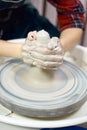 Woman making ceramic pottery on wheel, hands closeup. Concept for woman in freelance, business, creative hobby. Earn extra money, Royalty Free Stock Photo