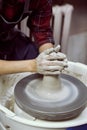 Woman making ceramic pottery on wheel, hands closeup. Concept for woman in freelance, business, creative hobby. Earn extra money, Royalty Free Stock Photo