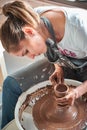 Woman making ceramic pottery on wheel, hands closeup. Concept for woman in freelance, business, hobby Royalty Free Stock Photo