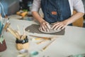 Woman making ceramics objects inside creative pottery studio - Art and workshop concept - Focus on hands Royalty Free Stock Photo