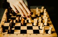 A woman making a chess move to checkmate her opponent. The strategy, intellectual challenges, and competition Royalty Free Stock Photo