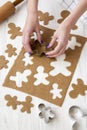 Woman making Christmas cookies on a white wooden background, side view Royalty Free Stock Photo