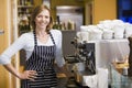 Woman making coffee in restaurant smiling Royalty Free Stock Photo