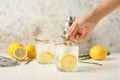 Woman making cold gin tonic on light background Royalty Free Stock Photo