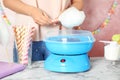 Woman making cotton candy using modern machine Royalty Free Stock Photo