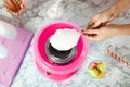 Woman making cotton candy using modern machine at table Royalty Free Stock Photo