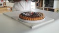 A woman making the dough for a sweet fruit tart at home in the kitchen