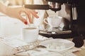 Woman making fresh espresso in coffee maker. coffee machine make