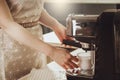 Woman making fresh espresso in coffee maker. coffee machine make