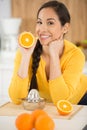 woman making fresh orange juice in kitchen Royalty Free Stock Photo