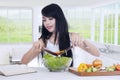 Woman making fresh salad in kitchen Royalty Free Stock Photo