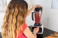 Woman making fruit smoothie