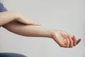 The woman is making a gesture by touching her arm with her hand Royalty Free Stock Photo