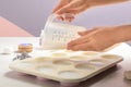 Woman making hand made soap bar with lavender flowers at table Royalty Free Stock Photo