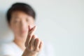 A person displays a love symbol from fingers in Korean style; selective focus at fingers