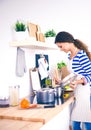 Woman making healthy food standing smiling in kitchen Royalty Free Stock Photo