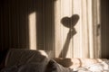 Woman making heart shadow on the wall. World mental health day, hope and love. Valentines 14 February Royalty Free Stock Photo