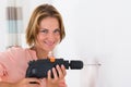 Woman Making Hole With Drill Machine