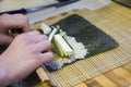 Woman making at home Japanese sushi rolls Royalty Free Stock Photo