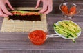 Woman making at home Japanese sushi rolls. Royalty Free Stock Photo