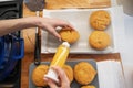 Woman making home made vegan doughnuts filling them with apricot jam Royalty Free Stock Photo