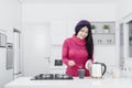 Woman making hot tea in kitchen Royalty Free Stock Photo