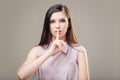 Woman making a hush gesture with her index finger on lips Royalty Free Stock Photo
