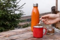 Woman making instant coffee at wooden table outdoors, closeup Royalty Free Stock Photo