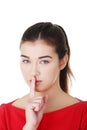 Woman making a keep it quiet gesture