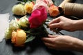 Woman making luxury bouquet of fresh roses at black table, closeup Royalty Free Stock Photo