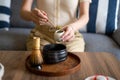 Woman making matcha green tea drink at home using tea ceremony set Royalty Free Stock Photo