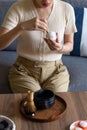 Woman making matcha green tea drink at home using tea ceremony set Royalty Free Stock Photo