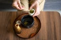 Woman making matcha green tea drink at home using tea ceremony set Royalty Free Stock Photo