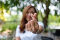 A woman making mini heart hand sign in the park