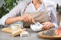 Woman making natural handmade soap at stone table, closeup