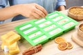 Woman making natural handmade soap at table, closeup