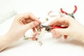 Woman making necklase from colorful plastic beads on light background