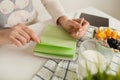 Woman making notes in notepad with healthy food on table Royalty Free Stock Photo